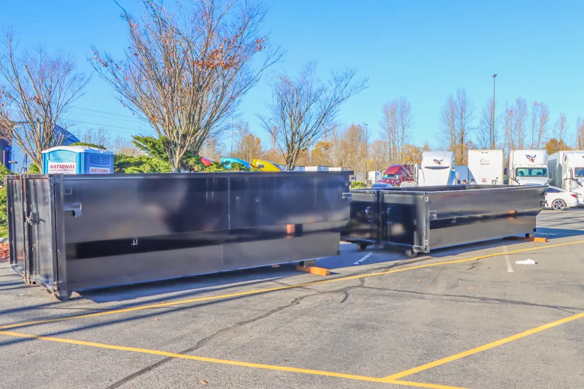 Professional dumpster rental service with roll-off container on residential driveway in North Little Rock